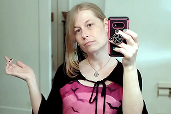 A picture of Jade in the mirror posing in a witch dress